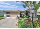 Charming single-story home with a well-manicured lawn and lovely landscaping at 18520 Hidden Pines Way, Hudson, FL 34667