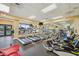 Well-equipped fitness center featuring treadmills, elliptical machines, and a mirrored wall at 18520 Hidden Pines Way, Hudson, FL 34667