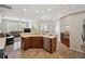 Open kitchen area with wooden cabinets, stone tile flooring, and stainless steel dishwasher at 18520 Hidden Pines Way, Hudson, FL 34667