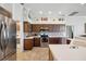 Well-lit kitchen featuring stainless steel appliances, tiled backsplash, and ample cabinet space at 18520 Hidden Pines Way, Hudson, FL 34667