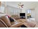 Open-concept living area with comfortable leather seating, tile floors, and access to outdoor patio at 18520 Hidden Pines Way, Hudson, FL 34667
