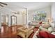 Bright living room featuring hardwood floors, large windows, and an open layout at 18520 Hidden Pines Way, Hudson, FL 34667