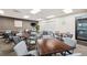 Well-lit room with wooden tables and comfortable seating, ideal for gatherings and activities at 18520 Hidden Pines Way, Hudson, FL 34667