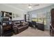 A functional home office featuring a leather sofa, built-in bookcase, and ample workspace perfect for productivity at 18520 Hidden Pines Way, Hudson, FL 34667