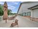 An expansive outdoor patio features multiple tables with chairs and umbrellas, adjacent to a building with large windows at 18520 Hidden Pines Way, Hudson, FL 34667