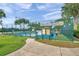 View of the Heritage Pines Pickleball courts, showing well-maintained blue courts, green fencing and landscaping at 18520 Hidden Pines Way, Hudson, FL 34667