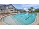 Beautiful community pool with swimming lanes and deck chairs surrounded by landscaped grounds at 18520 Hidden Pines Way, Hudson, FL 34667