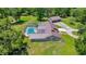 Aerial perspective highlighting the home's screened-in pool, and detached garage on a sprawling lot at 21000 Exeter Ct, Brooksville, FL 34601