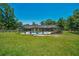 The backyard features a screened in pool, hot tub, spacious lawn and a wooded perimeter at 21000 Exeter Ct, Brooksville, FL 34601