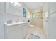 Light and airy bathroom features modern vanity, shower, and coastal decor at 21000 Exeter Ct, Brooksville, FL 34601