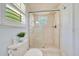 Clean bathroom featuring a tiled shower with glass door and neutral decor at 21000 Exeter Ct, Brooksville, FL 34601