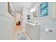 Well-lit bathroom featuring modern vanity, unique fixtures, and decorative art at 21000 Exeter Ct, Brooksville, FL 34601