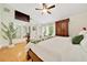 Bright bedroom featuring wood floors, closet, ceiling fan, and plant for a fresh look at 21000 Exeter Ct, Brooksville, FL 34601