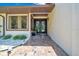 Close-up of home entrance featuring a brick path and unique double doors at 21000 Exeter Ct, Brooksville, FL 34601