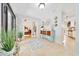 Welcoming foyer featuring travertine floors, modern decor, and view to the bedroom through sliding doors at 21000 Exeter Ct, Brooksville, FL 34601