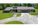 Inviting front yard showcasing a well-maintained lawn and a brick walkway to the home's entrance at 21000 Exeter Ct, Brooksville, FL 34601