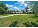 Manicured front lawn with a circular driveway leading to a house with a detached garage at 21000 Exeter Ct, Brooksville, FL 34601