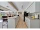 Bright kitchen features tile floors, white cabinets, granite countertops and eat-in island at 21000 Exeter Ct, Brooksville, FL 34601