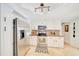 Well-lit kitchen with stainless steel appliances, granite countertops, mosaic backsplash, and white cabinets at 21000 Exeter Ct, Brooksville, FL 34601