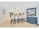 Bright kitchen bar area with granite countertop, bar stool seating, and light blue walls at 21000 Exeter Ct, Brooksville, FL 34601