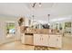 Open kitchen with stainless steel dishwasher and sink, granite counters, view to a pool, and white cabinets at 21000 Exeter Ct, Brooksville, FL 34601