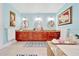 Vanity in luxurious main bathroom featuring granite countertops, decorative mirrors, and ample counter space at 21000 Exeter Ct, Brooksville, FL 34601