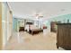 Bright main bedroom featuring a four-poster bed, an ensuite bath, and neutral tones for a cozy and relaxing ambiance at 21000 Exeter Ct, Brooksville, FL 34601