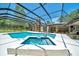 This screened in pool features a hot tub, water feature and plenty of room to relax at 21000 Exeter Ct, Brooksville, FL 34601