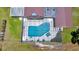 Aerial close up view of screened pool with jacuzzi and patio on a sunny day at 21000 Exeter Ct, Brooksville, FL 34601