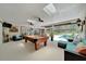 Spacious recreation room featuring a pool table, skylights, and access to the outdoor pool area at 21000 Exeter Ct, Brooksville, FL 34601