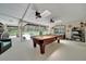 Inviting recreation room with a pool table, ceiling fans, and seamless access to the outdoor pool at 21000 Exeter Ct, Brooksville, FL 34601