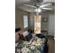 Cozy bedroom with a ceiling fan, closet, and an adjoining bathroom at 2158 Clayton Ave, Spring Hill, FL 34609