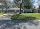 Charming home with a well-maintained lawn, mature trees, and a screened-in garage at 2158 Clayton Ave, Spring Hill, FL 34609