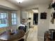 This wide view shows the dining area, kitchen, and entry to the home with tile flooring at 2158 Clayton Ave, Spring Hill, FL 34609