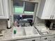 Bright kitchen sink area, featuring a window view and neutral countertops at 2158 Clayton Ave, Spring Hill, FL 34609