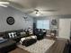 A cozy living room features a large sectional sofa, ceiling fan, and lots of natural light at 2158 Clayton Ave, Spring Hill, FL 34609
