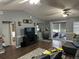 Open-concept living room with sliding glass doors, a large TV, and access to other rooms at 2158 Clayton Ave, Spring Hill, FL 34609