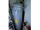 Modern water heater unit with energy guide label and nearby storage at 2158 Clayton Ave, Spring Hill, FL 34609