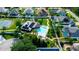 Aerial view of home with swimming pool, solar panels, manicured lawn, and tennis court at 21820 Carson Dr, Land O Lakes, FL 34639