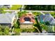 Aerial view of home's rear exterior, featuring pool, screened lanai, solar panels, and manicured backyard at 21820 Carson Dr, Land O Lakes, FL 34639