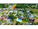 Community aerial view featuring homes, tennis courts, and a neighborhood pool nestled among trees at 21820 Carson Dr, Land O Lakes, FL 34639