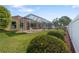 Screened patio offers an outdoor space to enjoy the well-manicured lawn and garden at 21820 Carson Dr, Land O Lakes, FL 34639