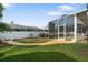 Backyard with well-maintained lawn and screen enclosed patio at 21820 Carson Dr, Land O Lakes, FL 34639