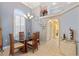 Elegant dining room featuring a glass table, neutral décor, and arched doorway, perfect for gatherings at 21820 Carson Dr, Land O Lakes, FL 34639
