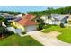 Inviting yellow two-car garage home featuring a red-tile roof, solar panels, and a well-manicured lawn at 21820 Carson Dr, Land O Lakes, FL 34639