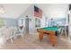 Game room featuring a billiards table, an American flag, several tables and chairs, and a kitchen area at 21820 Carson Dr, Land O Lakes, FL 34639