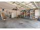 View of the spacious two car garage with shelving and storage space at 21820 Carson Dr, Land O Lakes, FL 34639