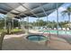 Covered hot tub featuring a pool in the background at 21820 Carson Dr, Land O Lakes, FL 34639