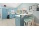 Bright kitchen features blue cabinets, white countertops and a breakfast bar with three stools at 21820 Carson Dr, Land O Lakes, FL 34639