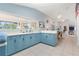 Kitchen in the community center featuring blue cabinets, stainless steel appliances, and a view of the pool at 21820 Carson Dr, Land O Lakes, FL 34639